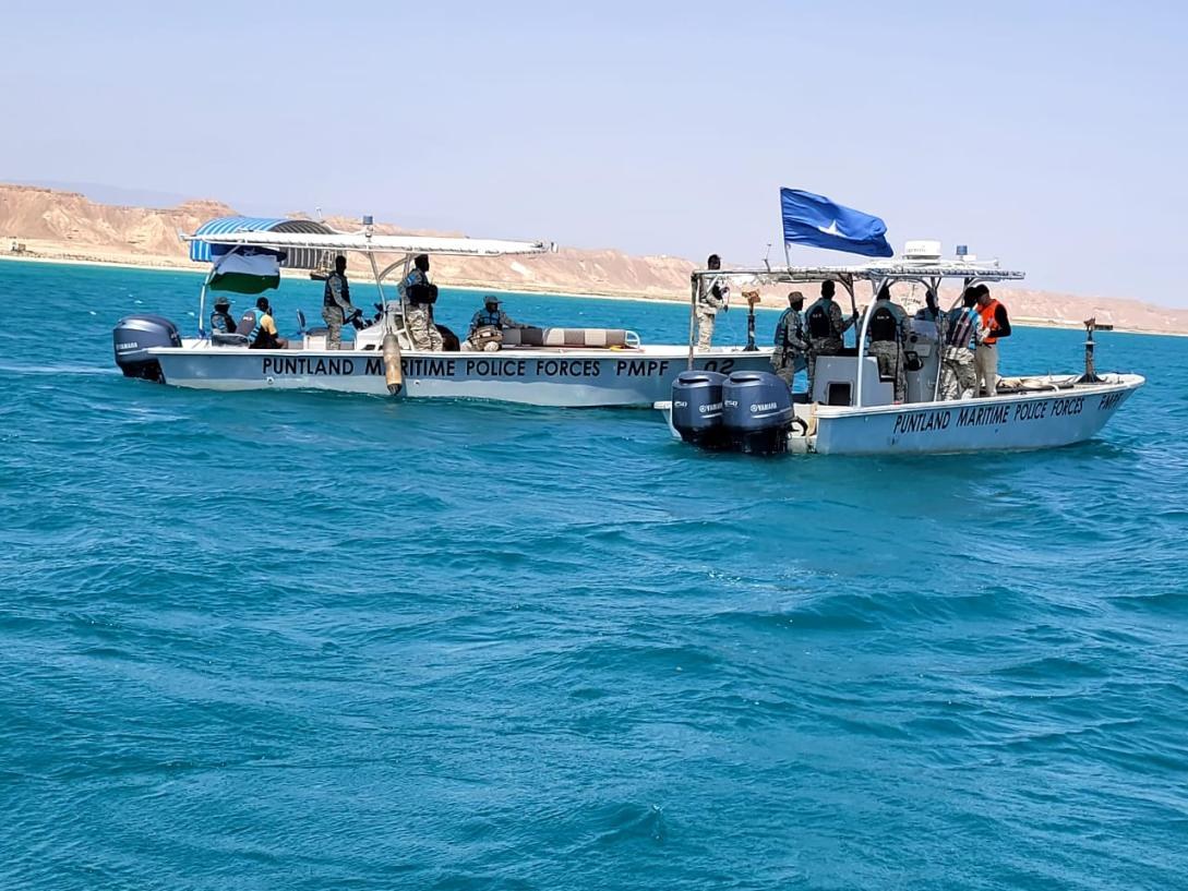Two boats marked Puntland Maritime Police Forces carrying personnel on coastal waters